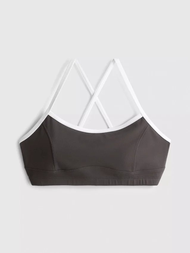 Aktives Crop-Top mit kontrastfarbener Paspelierung und gekreuztem Rücken