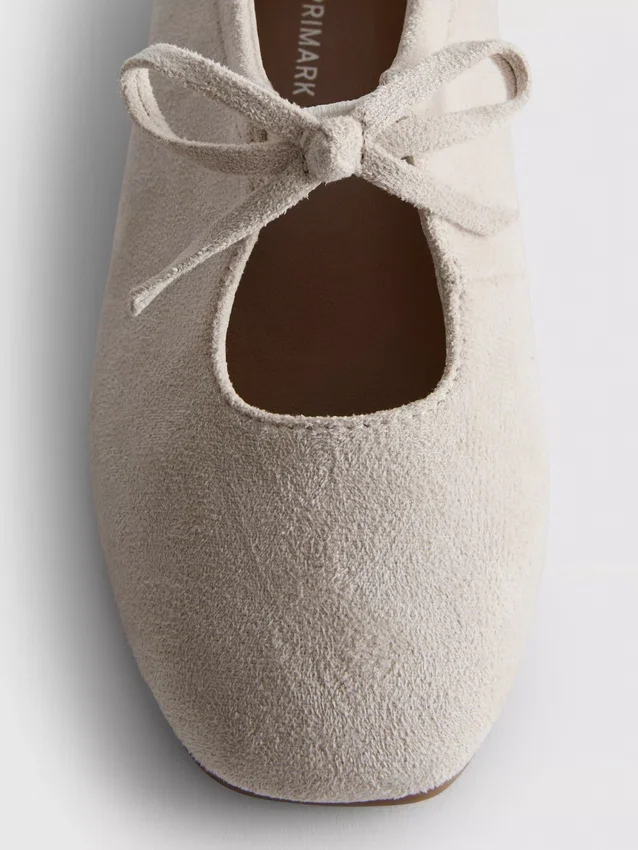 Ballerinas mit Schleifendetail als Detail an den Flachen Schuhen