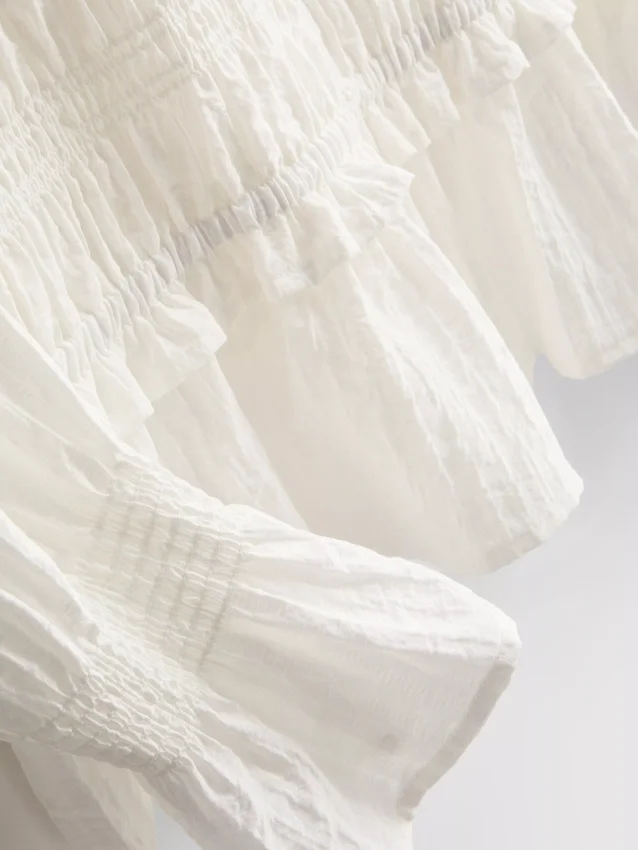Bluse mit gerafftem Peplum-Saum